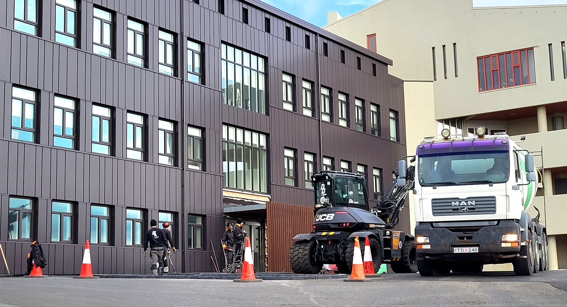 Unnið er nú að hellulögn og frágang fyrir framan húsið.